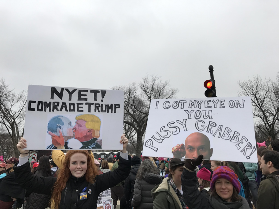 Two women with signs: Nyet! Comrade Trump and Luther from Key and Peele’s “Anger Translator” sketch: I got my eye on you pussy grabber 