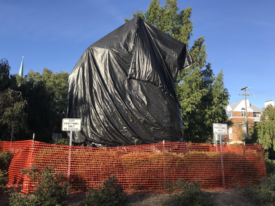 Garbage bag covering Confederate statue of Robert E. Lee in a public park